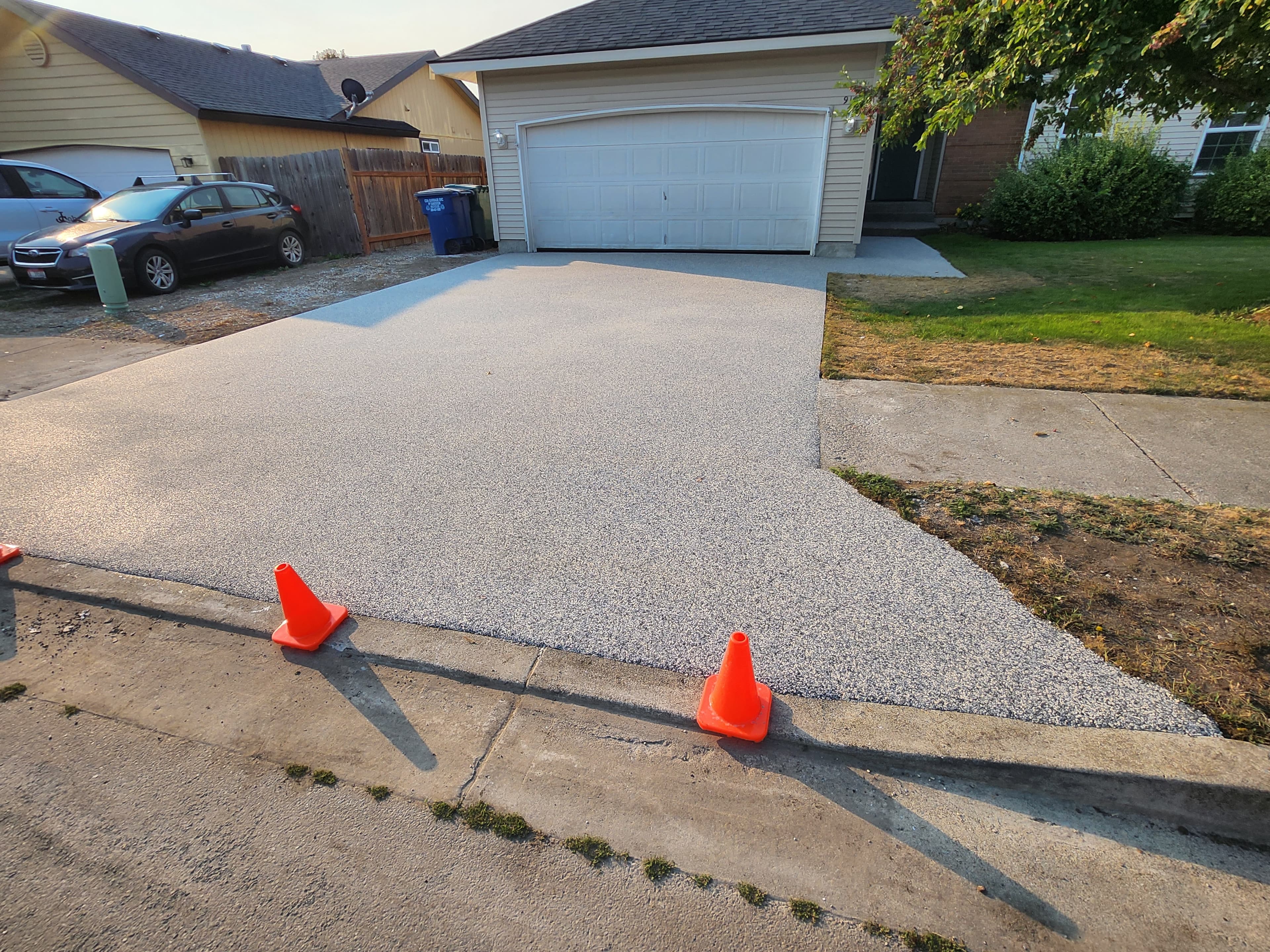 Finished resin-bound driveway with a smooth, modern grey aggregate blend