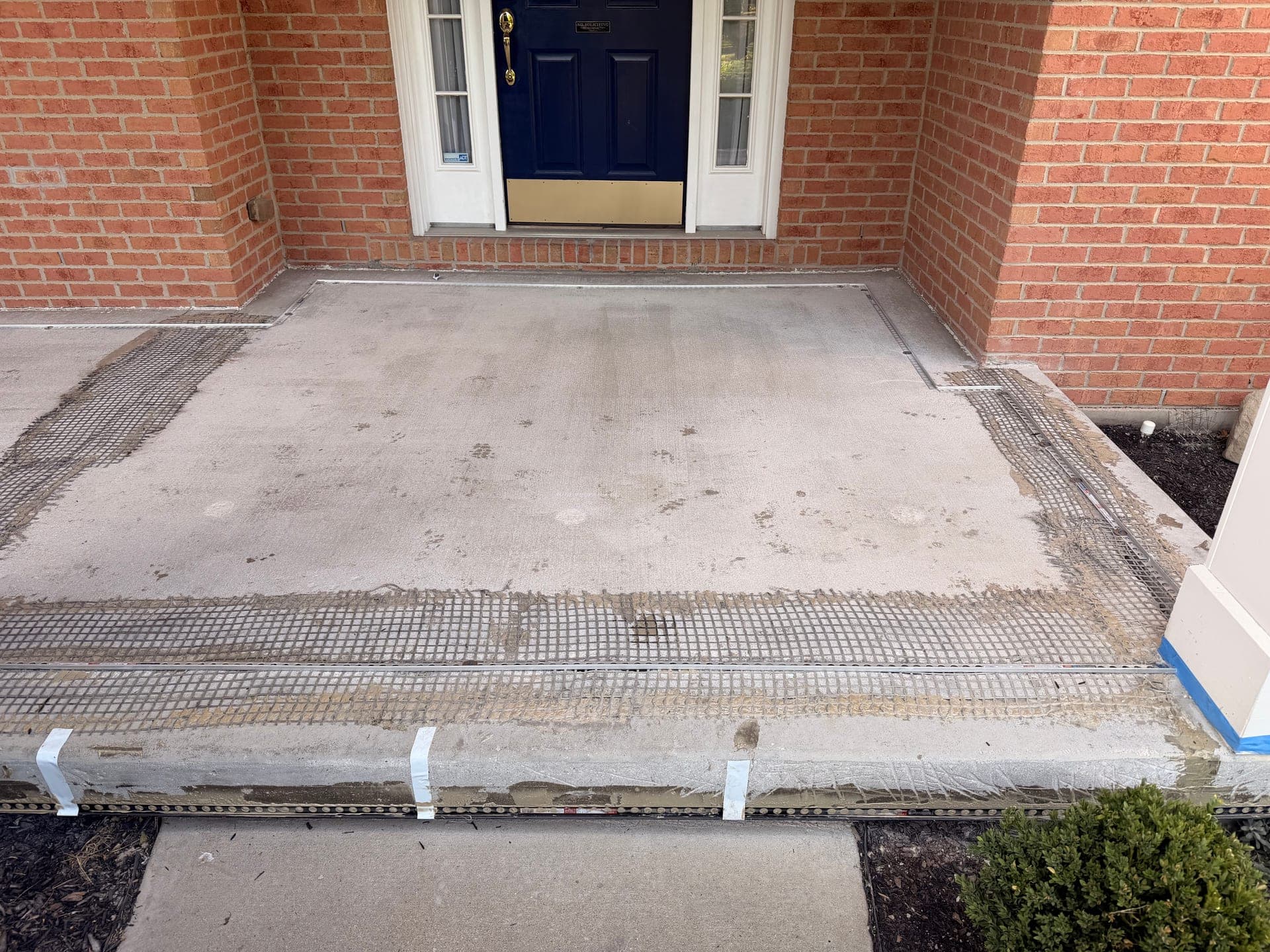 Mason covered porch before resin-bound resurfacing
