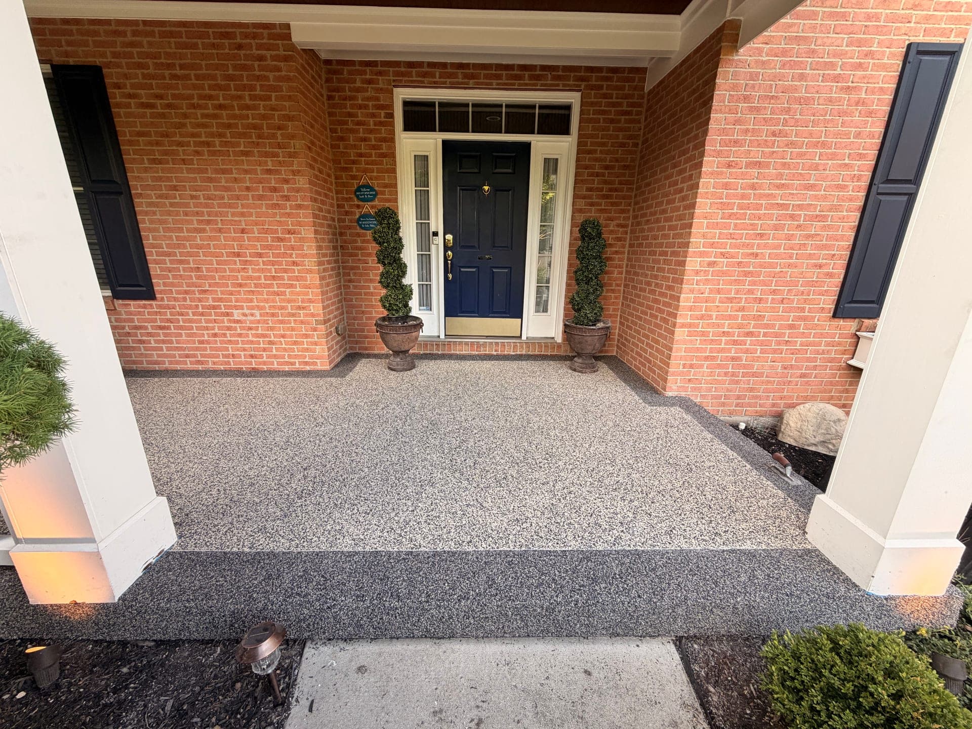 Mason covered porch after resin-bound stone install at the front entry